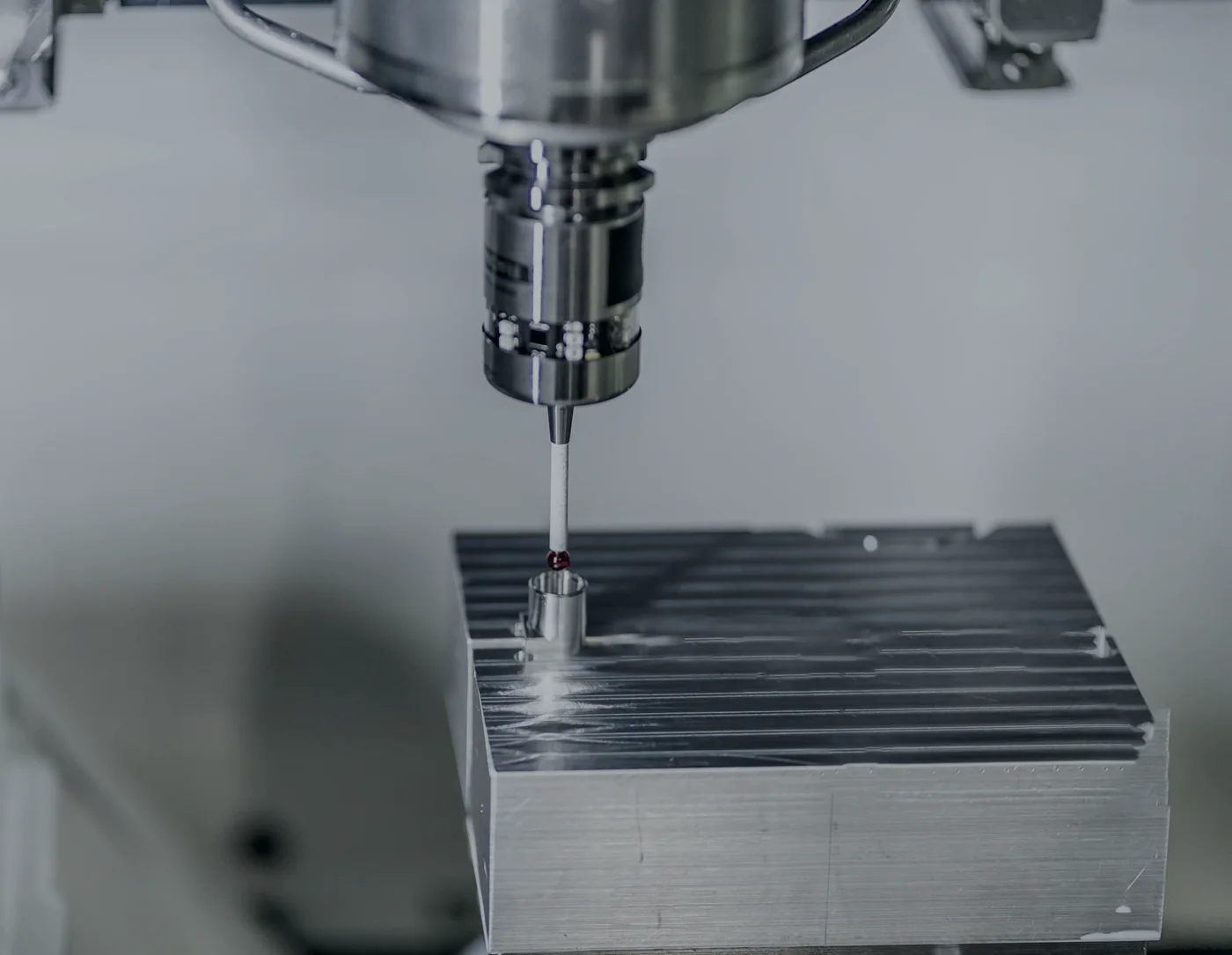 Measurement probe checking a machined part